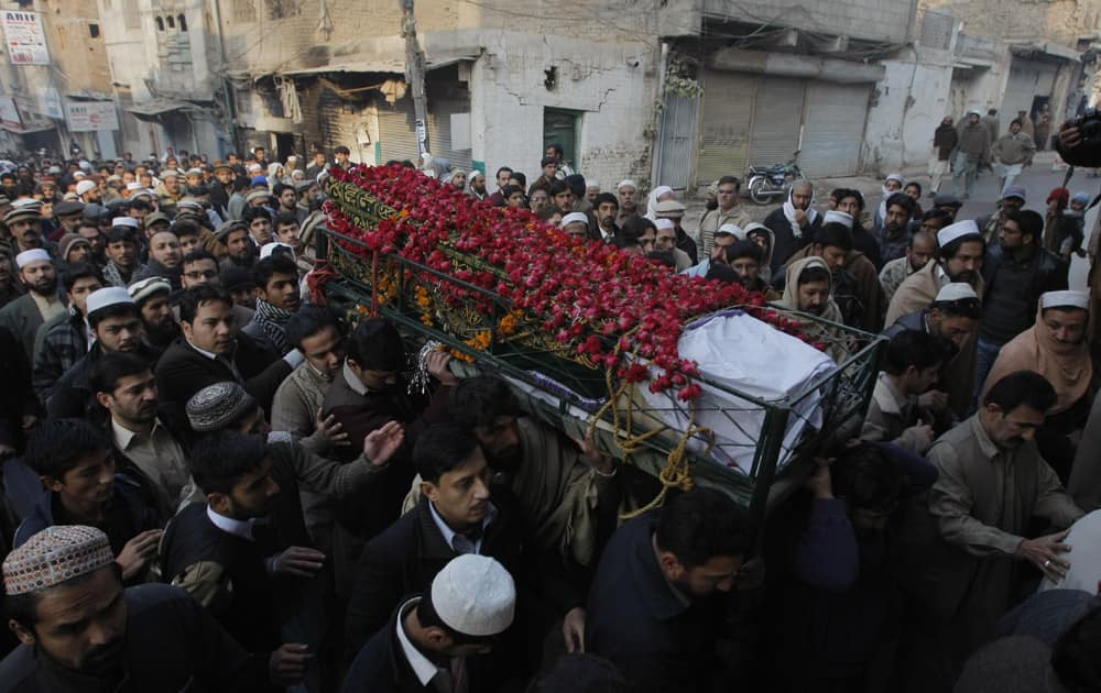 People attend funeral of a student killed in Tuesday's Taliban attack on a school in Peshawar, Pakistan.