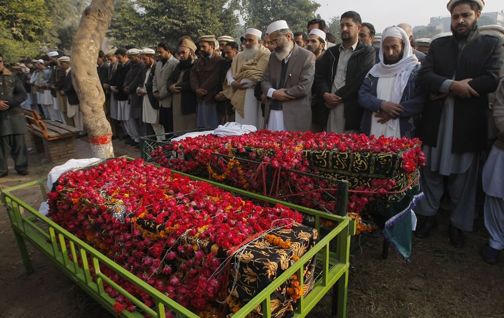 Siraj-ul-Haq, fourth right, chief of Pakistan's religious party Jammat-e-Islami, leads a funeral prayer for a student killed in Tuesday's Taliban attack on a school in Peshawar, Pakistan.