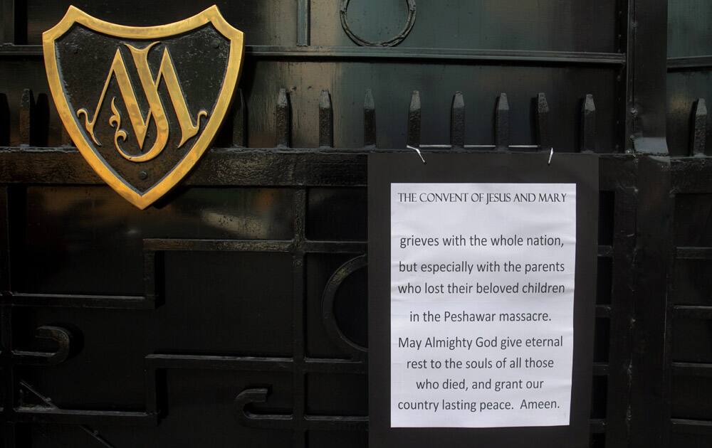 A notice on the entry gate is displayed by a missionary school administration to mourn for the victims of Tuesday's school attack in Lahore, Pakistan.