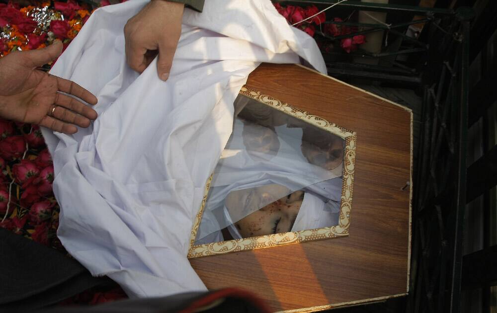 People attend a funeral of a student killed in Tuesday's Taliban attack on a school in Peshawar.