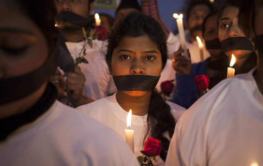 Indian women participate in a candle light vigil at a bus stop where the victim of a deadly gang rape in a moving bus had boarded the bus two years ago, in New Delhi, India.