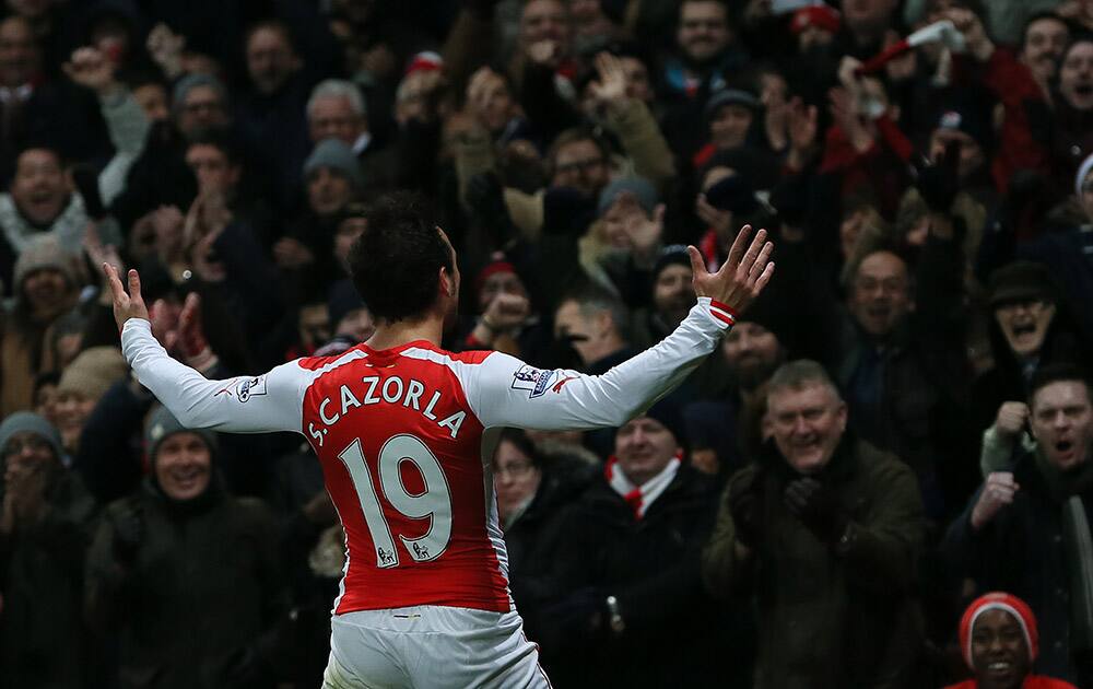 Arsenal’s Santi Cazorla celebrates after scoring a goal during the English Premier League soccer match between Arsenal and Newcastle United at the Emirates Stadium, London.