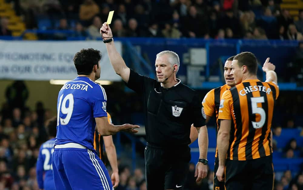 Chelsea's Diego Costa is shown a yellow card by referee Chris Hoy during their English Premier League soccer match between Chelsea and Hull City at Stamford Bridge stadium in London.