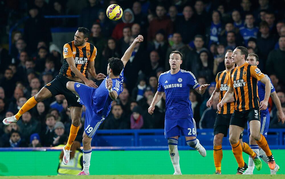 Hull’s Ahmed Elmohamady, left, challenges Chelsea's Diego Costa for the ball during their English Premier League soccer match between Chelsea and Hull City at Stamford Bridge stadium in London.