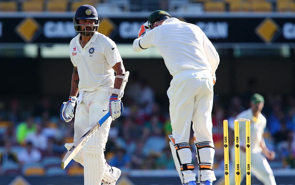 Murali Vijay, looks back to see he is out stumped by Australian wicketkeeper Brad Haddin during play on day one of the second cricket test in Brisbane, Australia.