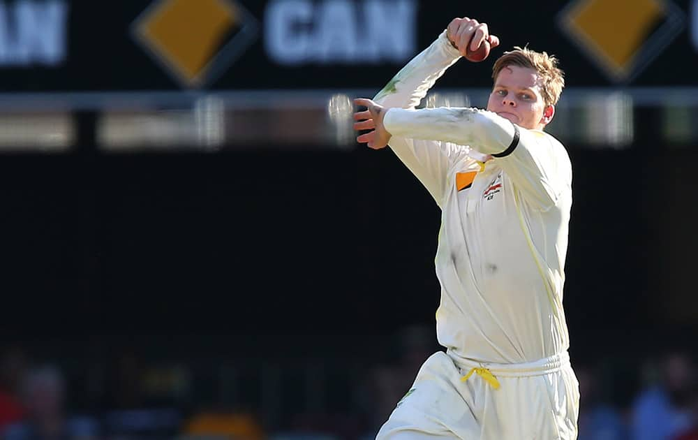 Australian captain Steven Smith prepares to bowl during play on day one of the second cricket test against India in Brisbane, Australia.