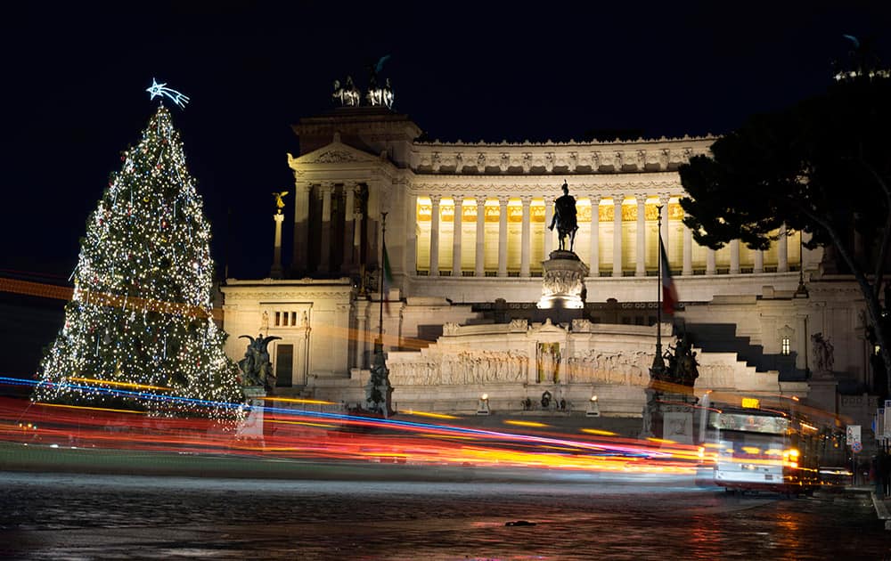 A bus passes by a Christmas tree that was set up in front of the Unknown Soldier Monument, in Rome.