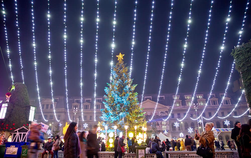 People walk at a Christmas fair in central Bucharest, Romania.