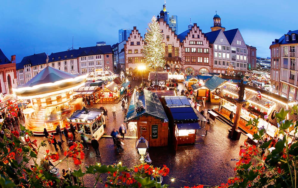 Only a few people visit the Christmas market on a rainy afternoon in Frankfurt, Germany.