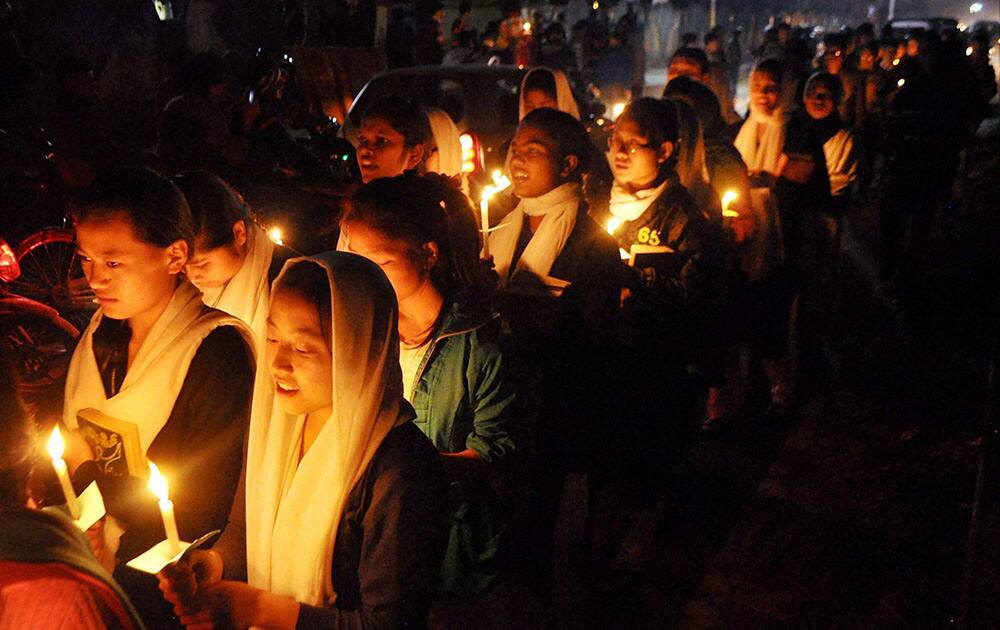 People take out a candle light carol procession during a pre-Christmas celebration at Catholic Church in Dibrugarh.