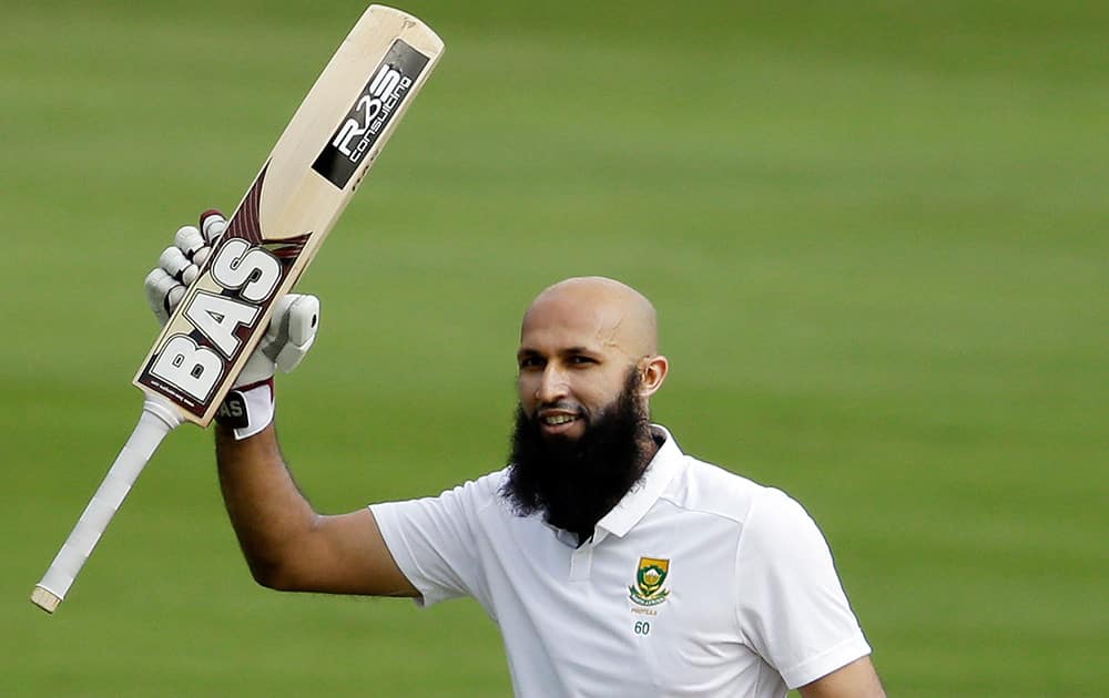 South Africa's captain Hashim Amla, celebrates his century on the first day of their 1st cricket Test match against West Indies at Centurion Park in Pretoria, South Africa.
