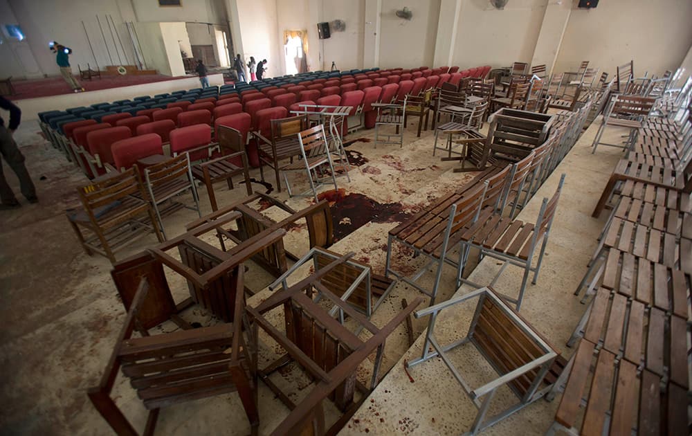Chairs are upturned and blood stains the floor at the Army Public School auditorium the day after Taliban gunmen stormed the school in Peshawar, Pakistan.