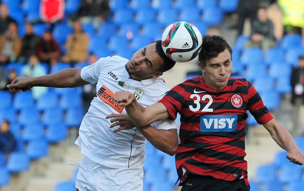 Western Sydney Wanderers' Daniel Alessi, right, and ES Setif's Mohamed Benyettou jump for the ball during the 5th place soccer match between ES Setif and Western Sydney Wanderers at the Club World Cup soccer tournament in Marrakech, Morocco.