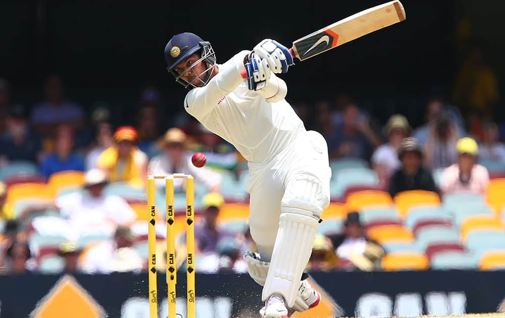 India's Umesh Yadav hits the ball for four runs during play on day two of the second cricket test against Australia in Brisbane, Australia.