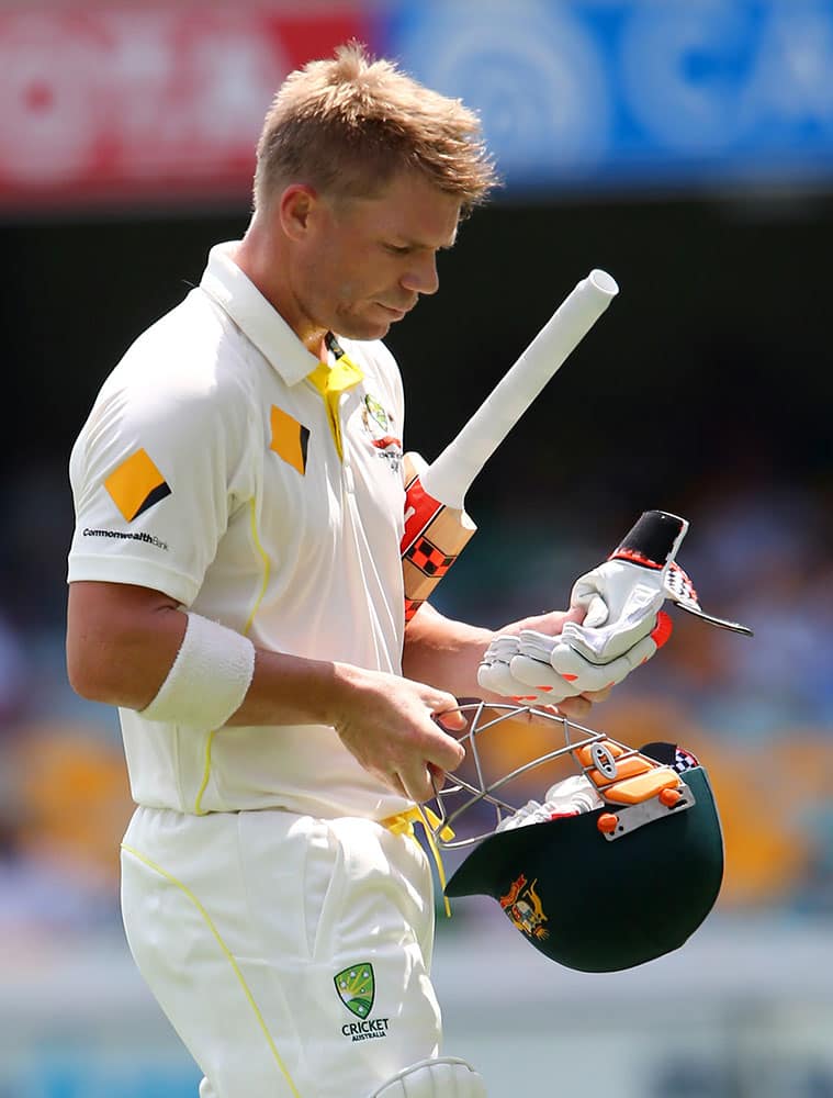 Australia's David Warner walks from the field after he was dismissed for 29 runs during play on day two of the second cricket test in Brisbane, Australia.