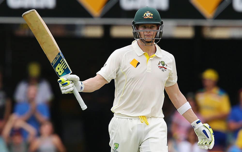 Australian batsman Steven Smith reacts after hitting a half century during play on day two of the second cricket test against India in Brisbane, Australia.