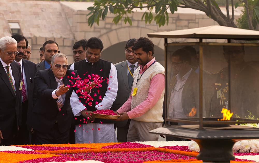 Bangladesh’s President Abdul Hamid throws flowers as he pays respect at Rajghat, the memorial to the late Mahatma Gandhi in New Delhi.