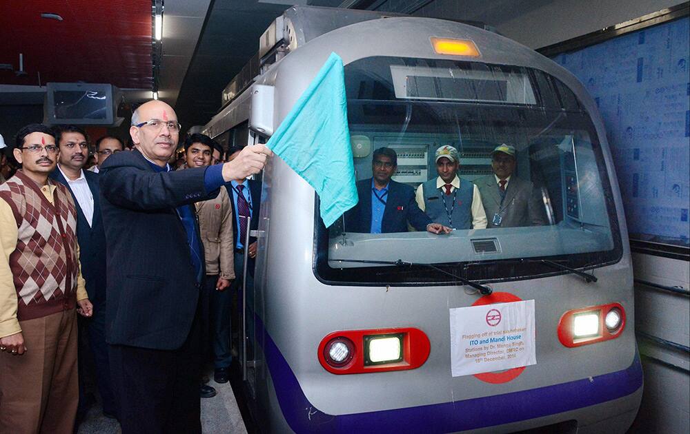 DMRC chief Mangu Singh flags off the trial run for a metro train on the newly built Mandi house- ITO route in New Delhi.