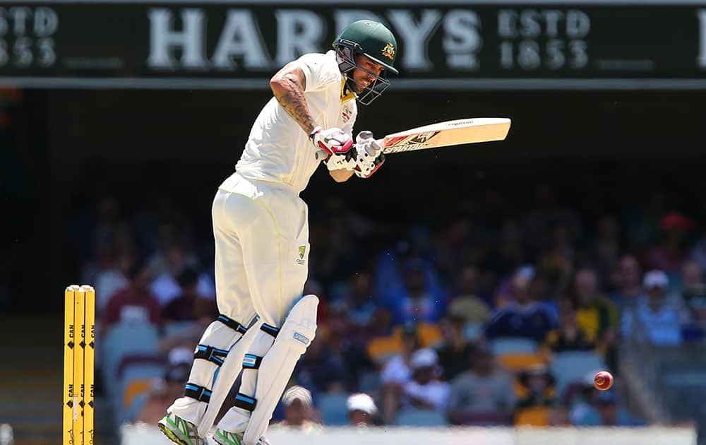 Mitchell Johnson plays a shot on the third day of the second cricket test against India in Brisbane, Australia.