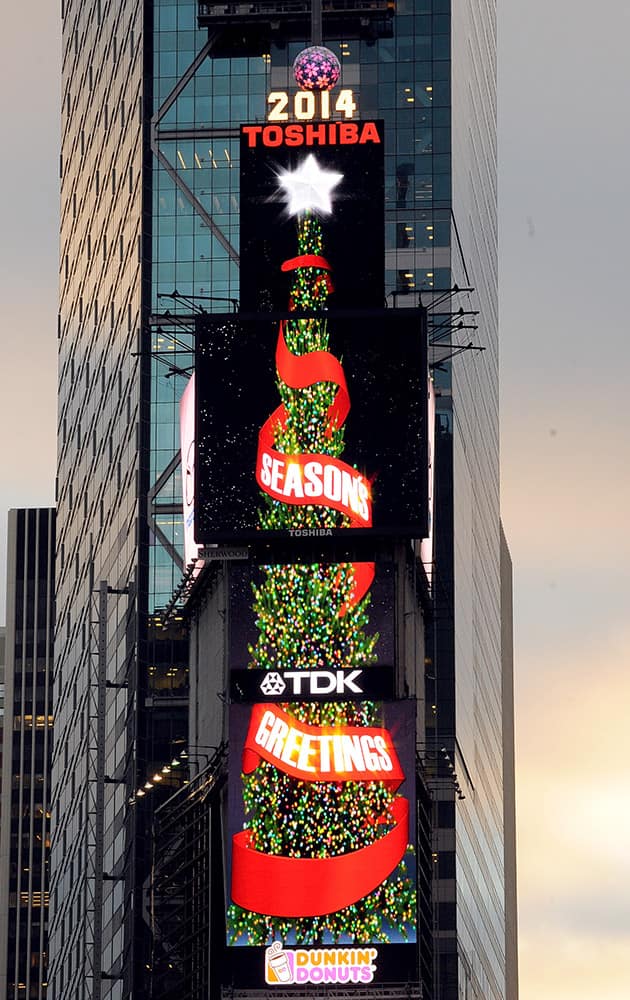 The world's tallest digitally-animated Christmas tree using four digital signs, for the first time, was lit today on One TImes Square, in New York. 