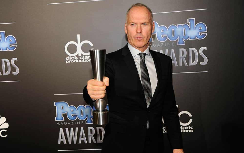 Michael Keaton poses backstage with the award for movie performance of the year - actor at The People Magazine Awards at the Beverly Hilton hotel, in Beverly Hills, Calif.