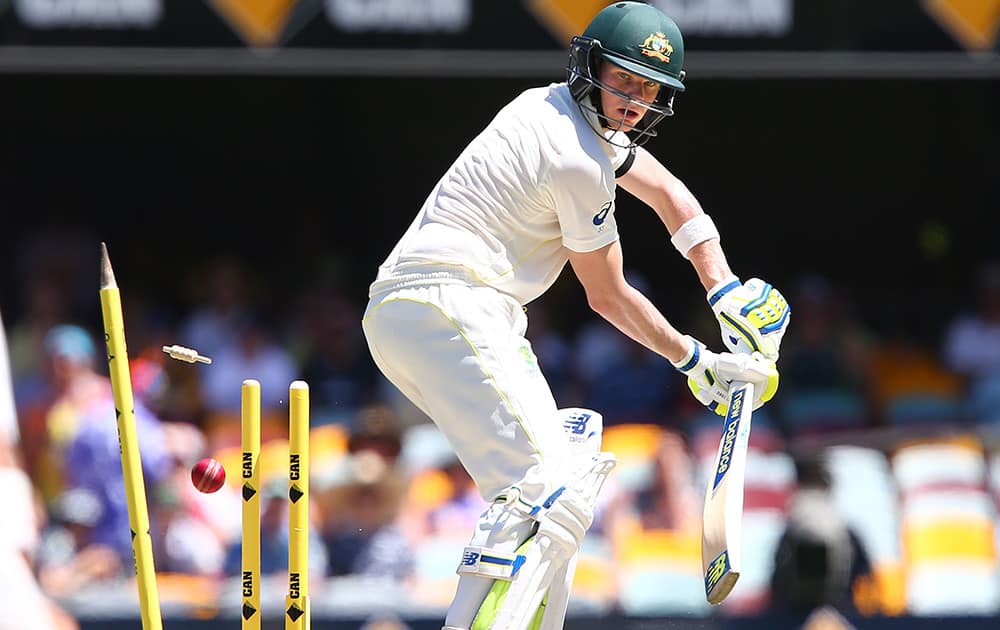 Australia's Steve Smith is bowled out by India's Ishant Sharma on the third day of the second cricket test in Brisbane, Australia.