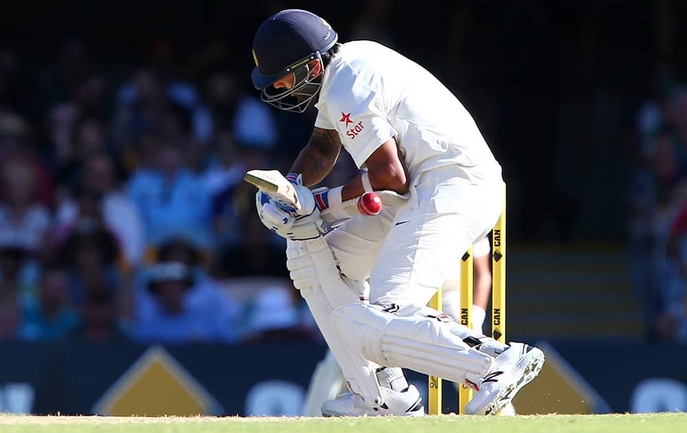 Murali Vijay reacts after being hit by the ball during play on day three of the second cricket test between Australia and India in Brisbane, Australia.