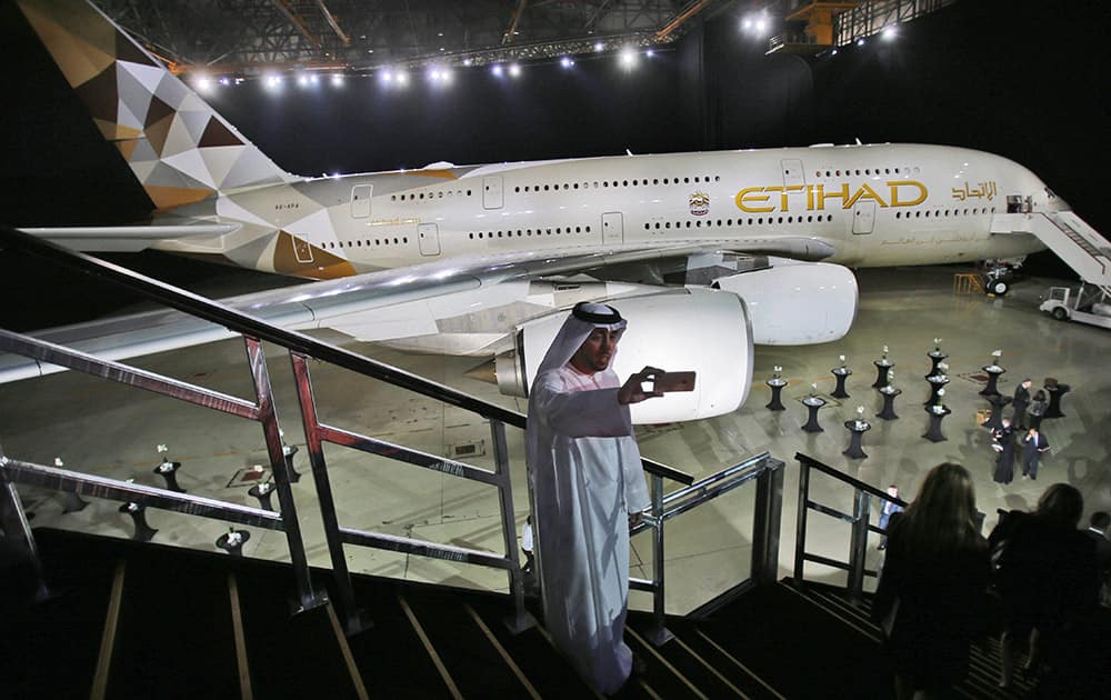 An Emirati man takes a selfie in front of a new Etihad Airways A380.