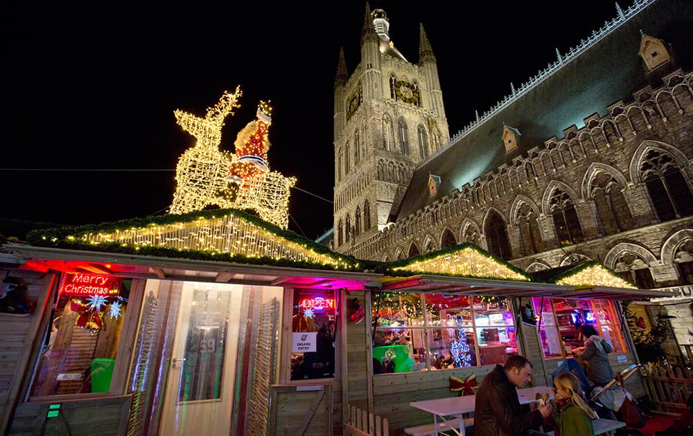 People spend time at a Christmas market in the town square of Ypres, Belgium.