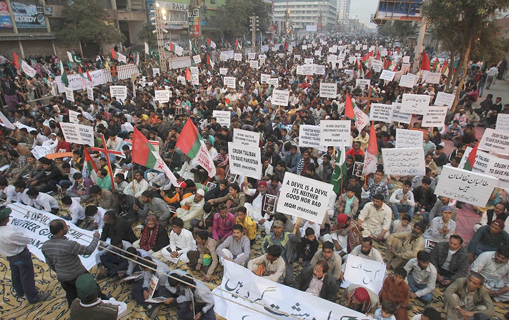 Supporters of Pakistans political party Muttahida Qaumi Movement express solidarity with families of the students killed in Tuesdays Taliban attack on a military-run school in Peshawar, as they rally in Karachi.