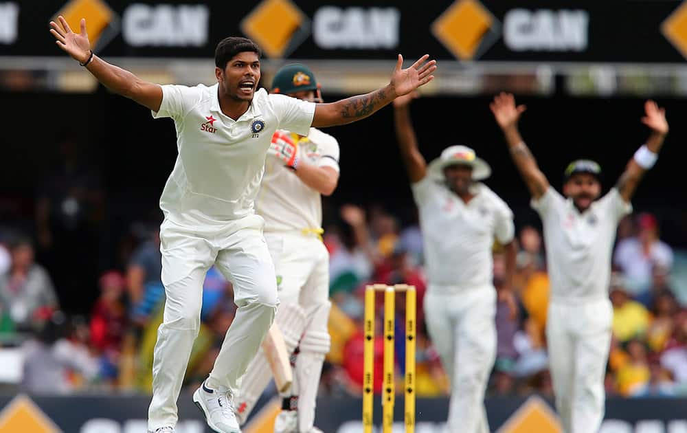 Umesh Yadav, appeals for the wicket of Australia's David Warner during their play on day four of the second cricket test in Brisbane.