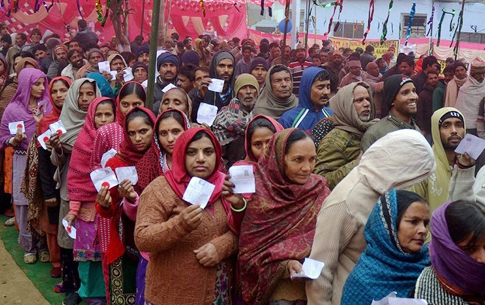 Voters wait in queues to cast their vote at a polling station during J&K Assembly elections in Kathua district of Jammu and Kashmir.