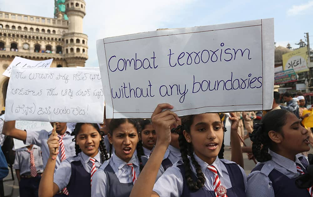 Schoolgirls hold placards during a rally to pay homage to victims of Tuesday's Taliban attack on a military-run school in Peshawar, in Hyderabad.