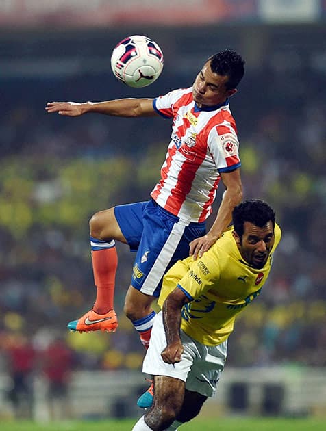 Kerla Blasters FC players (yellow) in action against the Atletico De Kolkata players during the final match of the ISL played in Mumbai.