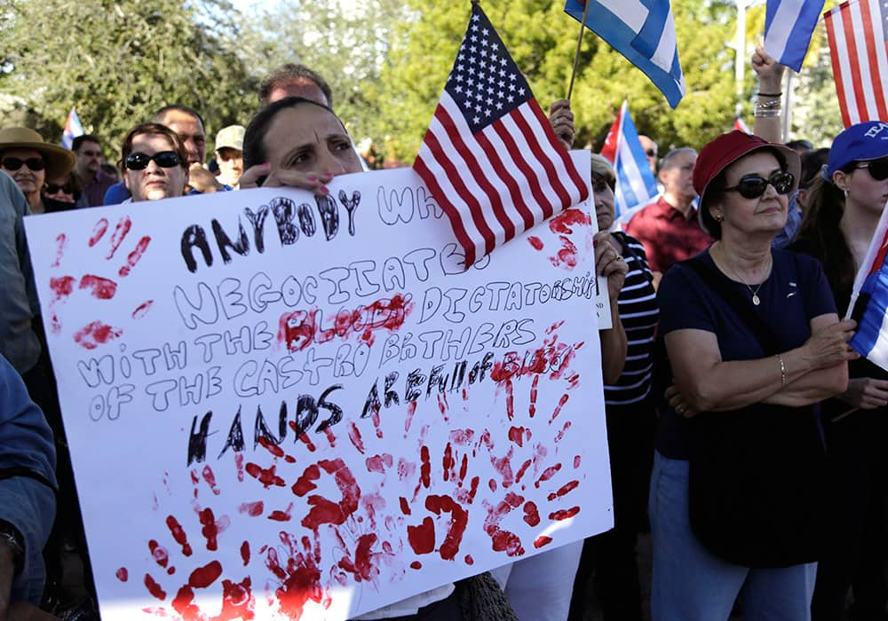 Sonia San Martin holds a sign during a protest in the Little Havana neighborhood of Miami against President Barack Obama's plan to normalize relations with Cuba. 