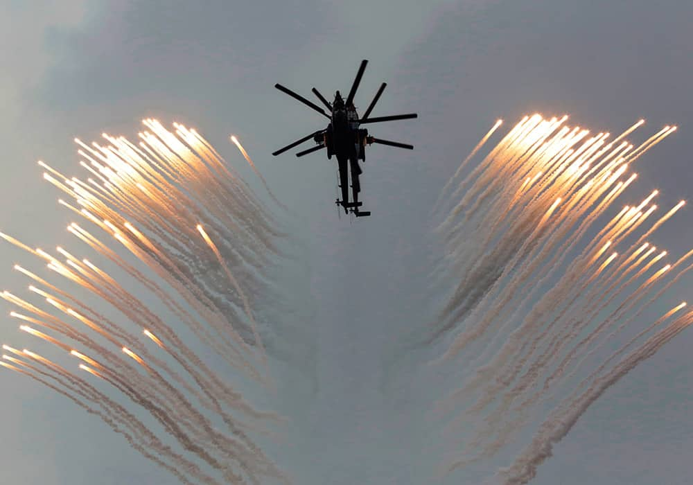 A couple of Russian Army helicopters fly over the Monument to Scuttled Ships, during a promotional campaign for contract service for Russian Army in Sevastopol, Crimea.