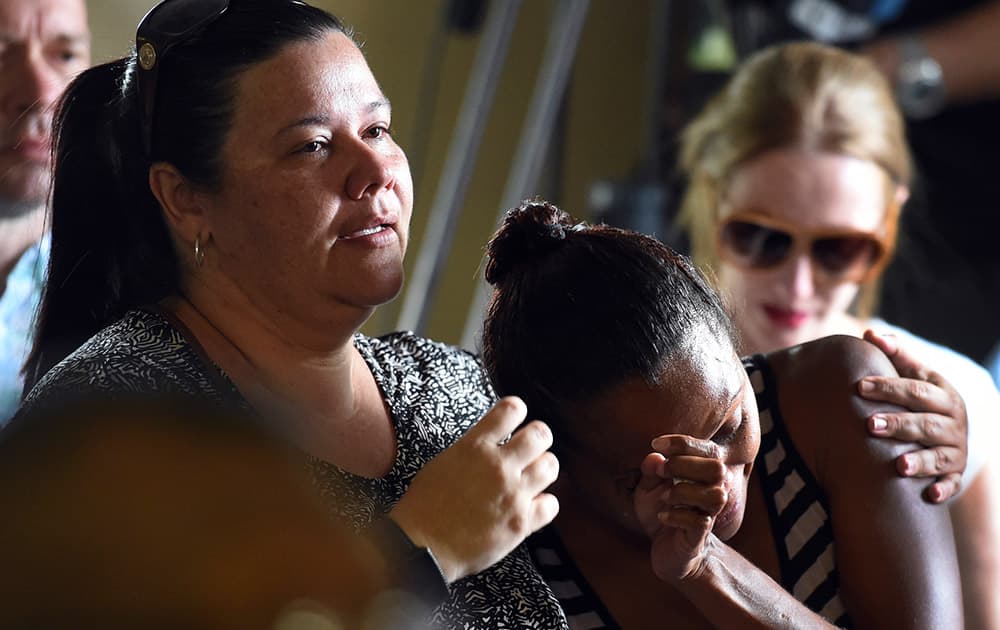 A woman cries during a church service to remember eight children who were killed in the Cairns suburb of Manoora.