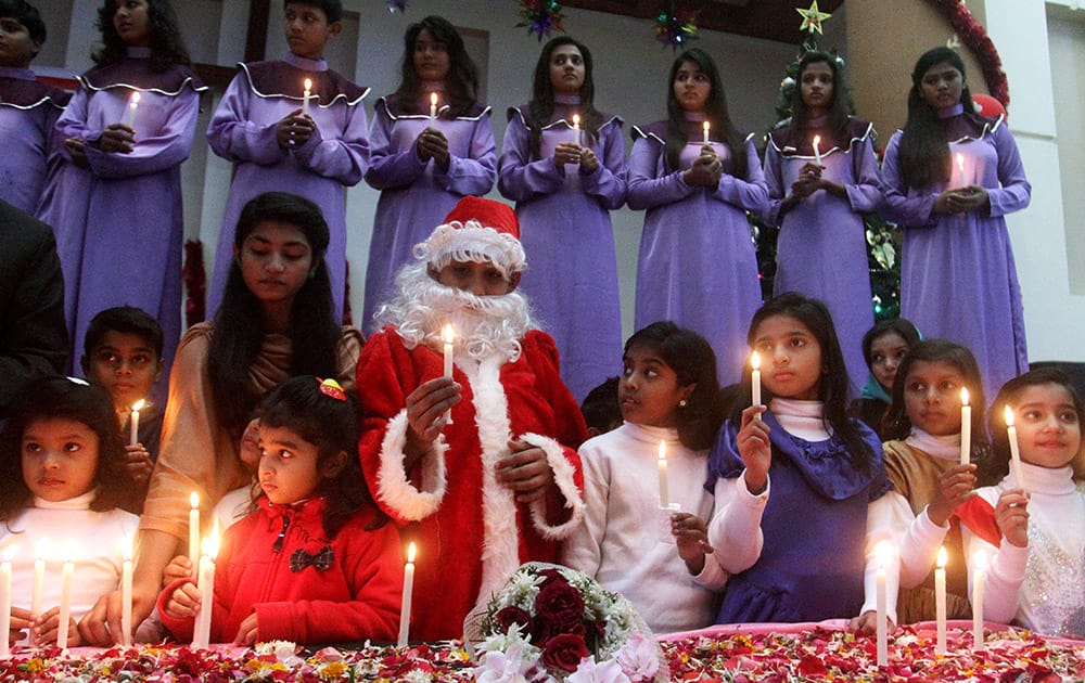 Pakistani Christian children take part in a prayer for victims killed in last Tuesday's Taliban attack on a military-run school, in Lahore, Pakistan.