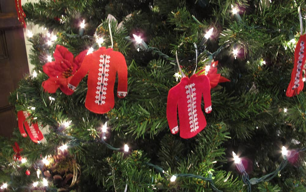 Several red shirt ornaments are on a Christmas tree at the mansion at Oakley Park.