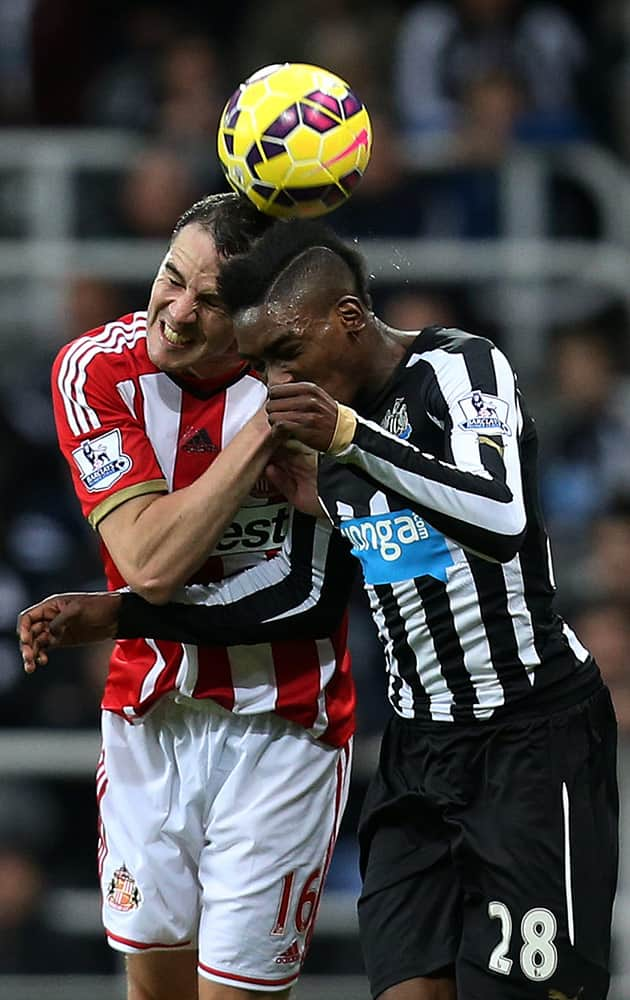 Newcastle United's Sammy Ameobi, right, vies for the ball with Sunderland's captain John O'Shea, left, during the English Premier League soccer match between Newcastle United and Sunderland, at St James' Park, Newcastle, England, Sunday.