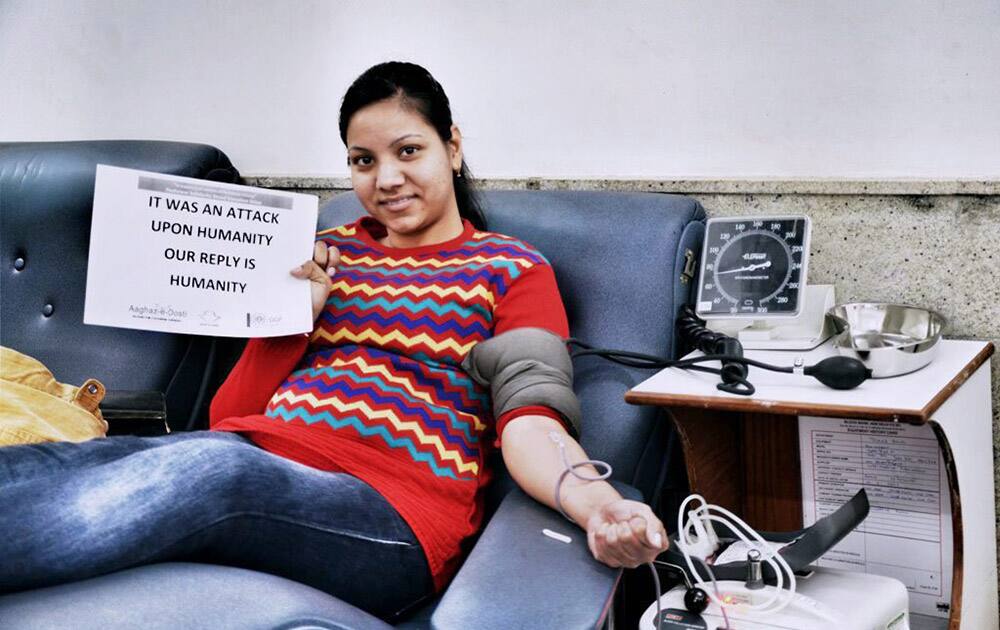 A young girls donates blood in solidarity with victims of Peshawar school attack during a blood donation drive at Indian Red Cross Society head quarters in New Delhi.