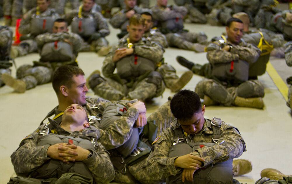 US Army soldiers of the 4th Infantry Brigade, Combat team (Airborne) 25th Infantry Division, part of the NATO-led peacekeeping mission in Kosovo rest before a parachute jump training exercise in U.S military base Camp Bondsteel, near the village of Sojeve in Kosovo.