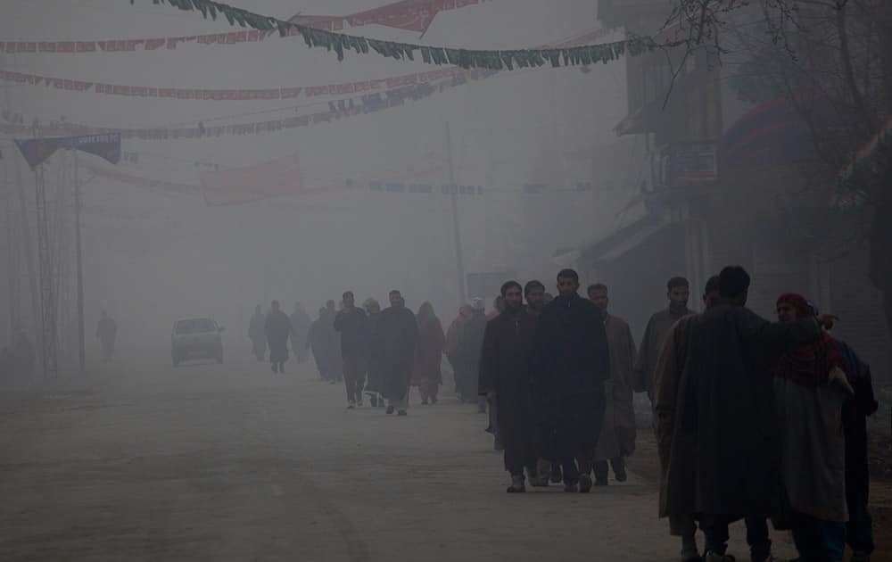 Kashmiris walk towards a polling station to cast their votes on a cold and foggy morning in Kulangham, some 68 kilometers north of Srinagar.