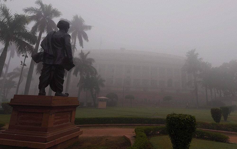 A view of Parliament House during a foggy morning as the temperature dropped in the national capital on Monday.