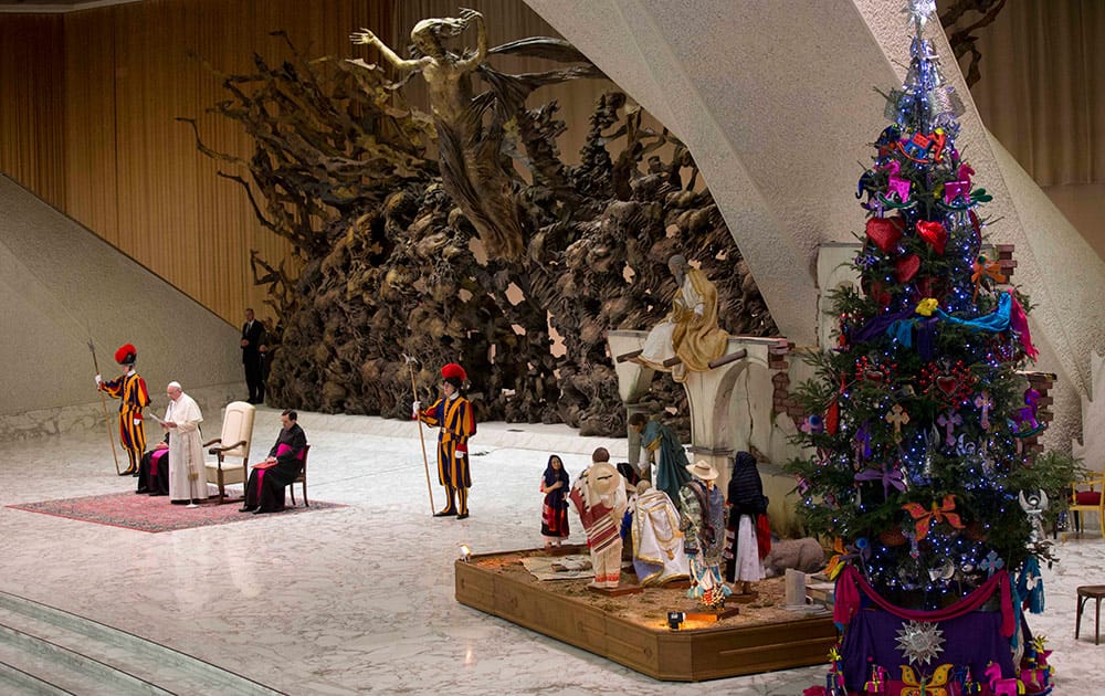 Pope Francis delivers his speech during an audience with the Holy See's employees in the Paul VI hall at the Vatican, Monday.