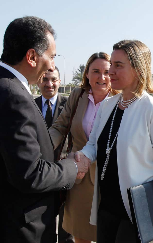 European Union foreign policy chief Federica Mogherini, right, shakes hands with Iraq's Deputy Foreign Minister Nizar al-Khairallah at Baghdad Airport in Baghdad, Monday.