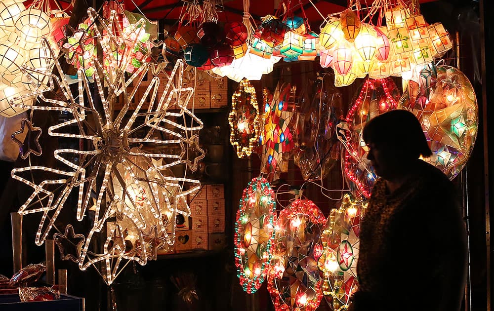 A Filipino woman looks at Christmas lanterns for sale in Manila, Philippines on Monday.