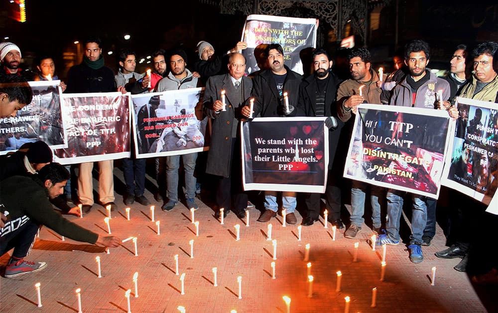 Lawyers and Locals holding candle light vigil to pay tribute to victims of Taliban terror attack in Peshawar,at Ghanta Ghar in the Heart of Srinagar.