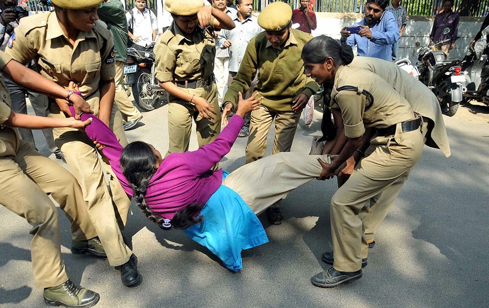 Police personnel arrest Indira Kranti Padakam activists during Chalo Assembly rally demanding to pay pending salaries, in Hyderabad.