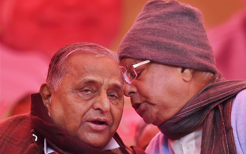 SP Chief Mulayam Singh Yadav chats with RJD President Lalu Yadav during the protest by Janata Parivar against Modi govt at Jantar Mantar in New Delhi.
